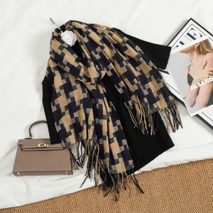 Detailed view of khaki and navy houndstooth pattern scarf with soft fringe tassels