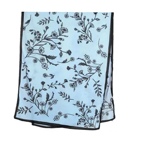 Elegant light blue long scarf featuring black floral prints and delicate black edges