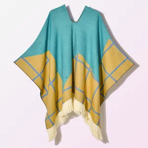 Detail of teal and ginger checkered knit shawl with thick cream-colored fringes