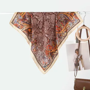 Elegant vintage paisley square silk scarf in brown and beige colors with bohemian patterns