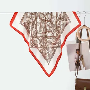 Detail of velvet square scarf with baroque pattern, red border and magnetic buckle