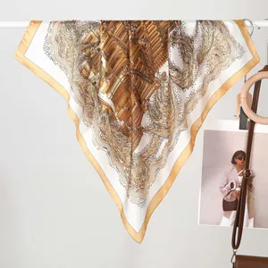 Baroque style silk scarf with vintage Roman patterns and gold border shown on a display stand
