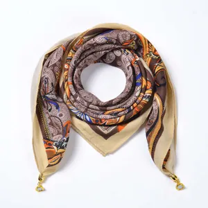 Detail of velvet square scarf with paisley pattern and golden magnetic metal rings