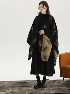 Close-up of black cashmere knit shawl with golden ginkgo leaves and contrast edges