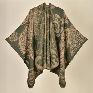 Close-up of olive green and beige paisley pattern on thick knit winter poncho shawl