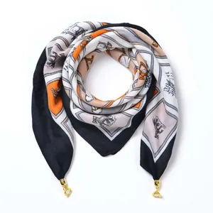 Detail of vintage velvet scarf with animal print and elegant gold metal ring charms