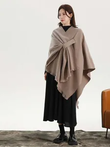 Detail of camel wool shawl showing asymmetric cut and draped texture with side strap