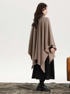 Side view of elegant solid color shawl cape with side ties and fringed hemline