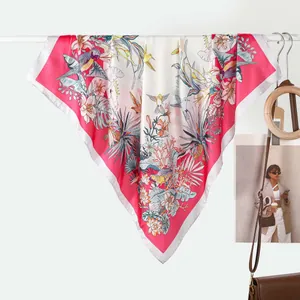 Detail of premium silk square scarf with tropical floral print and parrot motifs