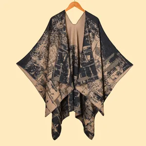 Detail of double-sided jacquard knit poncho shawl with navy and khaki marble texture