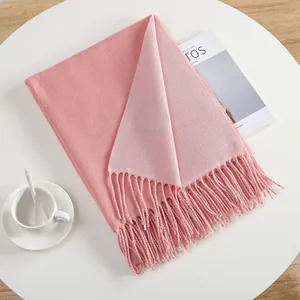 Detail of pink two-sided pashmina scarf with woven texture and elegant fringe edges