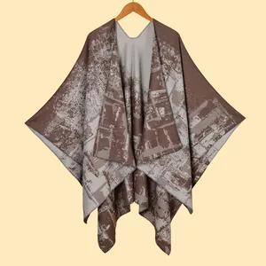 Detailed close-up showing geometric knit texture and soft fabric of this warm poncho shawl