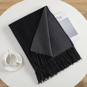Detail of double-sided cashmere-like scarf with fringe and soft knit texture