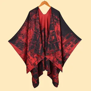 Detail of red and black knit poncho shawl with abstract crackle pattern and soft drape