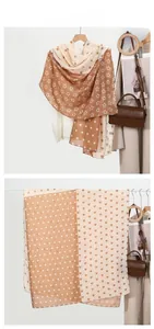 Detail view of heart and polka dot printed scarf in soft beige and brown tones