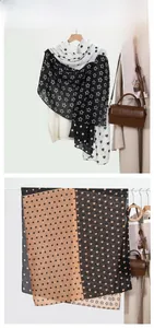 Detail of polka dot and star printed cotton linen scarf draped on a white shirt