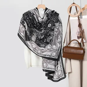 Retro paisley print scarf for women in black and white shown with an elegant outfit