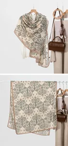 Detail view of a beige paisley scarf showing elegant texture and tile display on white