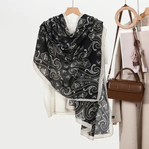 Black and beige paisley printed oversized shawl scarf for women on wooden hanger