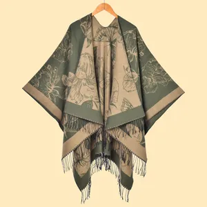 Detail shot of heavy floral knit shawl with elegant long fringes and premium texture