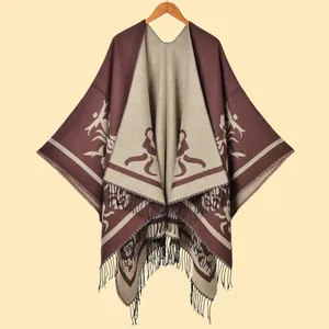 Detailed knit texture of a brown and beige jacquard shawl with decorative black fringe