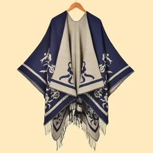 Vintage oversized women's knit shawl poncho with abstract floral pattern and tassels