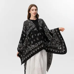 Close-up of vintage paisley and floral jacquard patterns on a black knit shawl