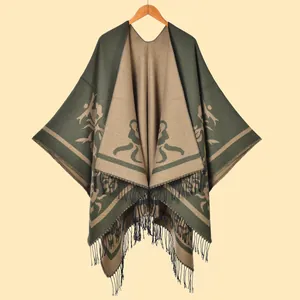 Detail of winter green knit shawl with vintage floral jacquard and fringe edges