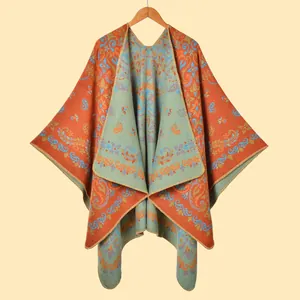 Detail of vintage paisley pattern on a knitted warm travel shawl with orange and blue tones