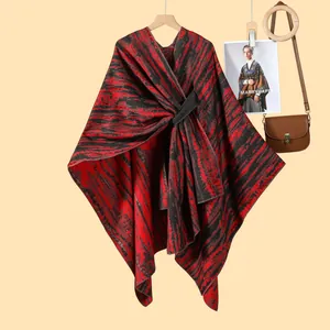 Detail of red and black striped bohemian knit shawl with elegant waist belt