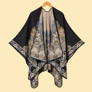 Bohemian paisley knit shawl cape with fringe and intricate geometric patterns in black and gold