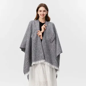 Detailaufnahme des grauen Tweed-Strickschals mit weichen weißen Fransen für Damen