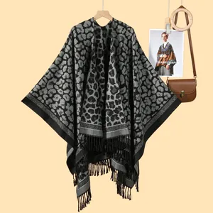 Classic leopard print shawl with long black tassels in a knitted poncho wrap design