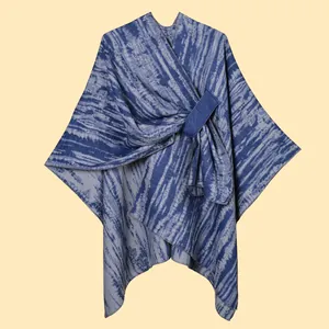 Detail of blue and white striped knit shawl featuring a secure blue rectangular buckle