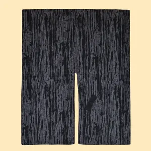 Detail shot of vintage dark grey tree bark pattern fabric with neat hem stitching