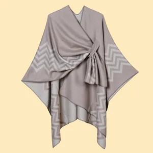 Detail of wave-patterned knit shawl with cross-knot design and fine edge stitching