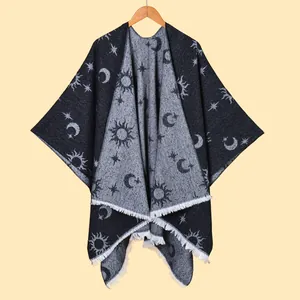 Detail view of celestial sun moon print on knit poncho with delicate fringe hem