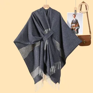 Detail view of blue-gray knit shawl with soft fringes and adjustable waist tie belt