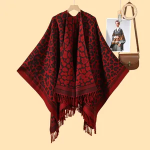 Detail of red and black leopard print shawl with fringe trim and stylish accessories