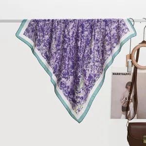 Detail of silk scarf with purple lavender print and white border hung on a display rod