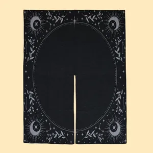Detail of celestial moon and star pattern on a black fringe cashmere-feel shawl cape