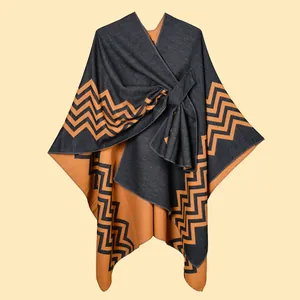 Detail view of double-sided knit shawl showing caramel orange weave and geometric patterns