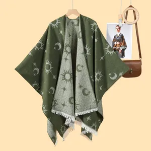 Green knit shawl poncho with celestial sun and moon jacquard patterns and fringe trim