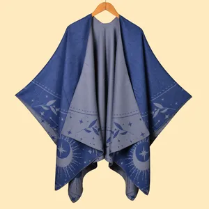 Detailed close-up of double-sided fringe poncho with star and leaf patterns in blue and grey