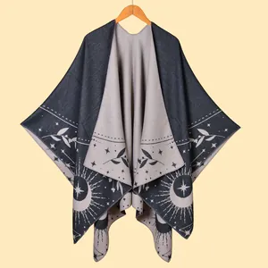 Detail of cashmere-like shawl featuring sun, moon, and star patterns with tassels
