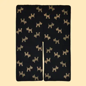 Close-up of thick knitted fabric with woven Scottish Terrier jacquard pattern