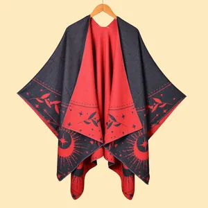 Detail of tassel poncho shawl with red and black star moon patterns and edge stitching
