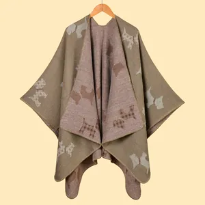 Detail of a brown knitted shawl with light terrier patterns and neat edge stitching