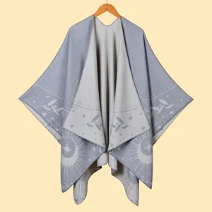 Detail of bohemian knit shawl with sun and star patterns and fringe trim detail