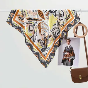 Silk-feel square scarf with floral geometric prints hanging on a white rack